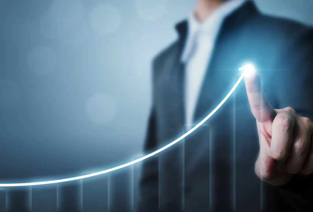 Business Man pointing with finger on screen drawing an exponential growth curve
